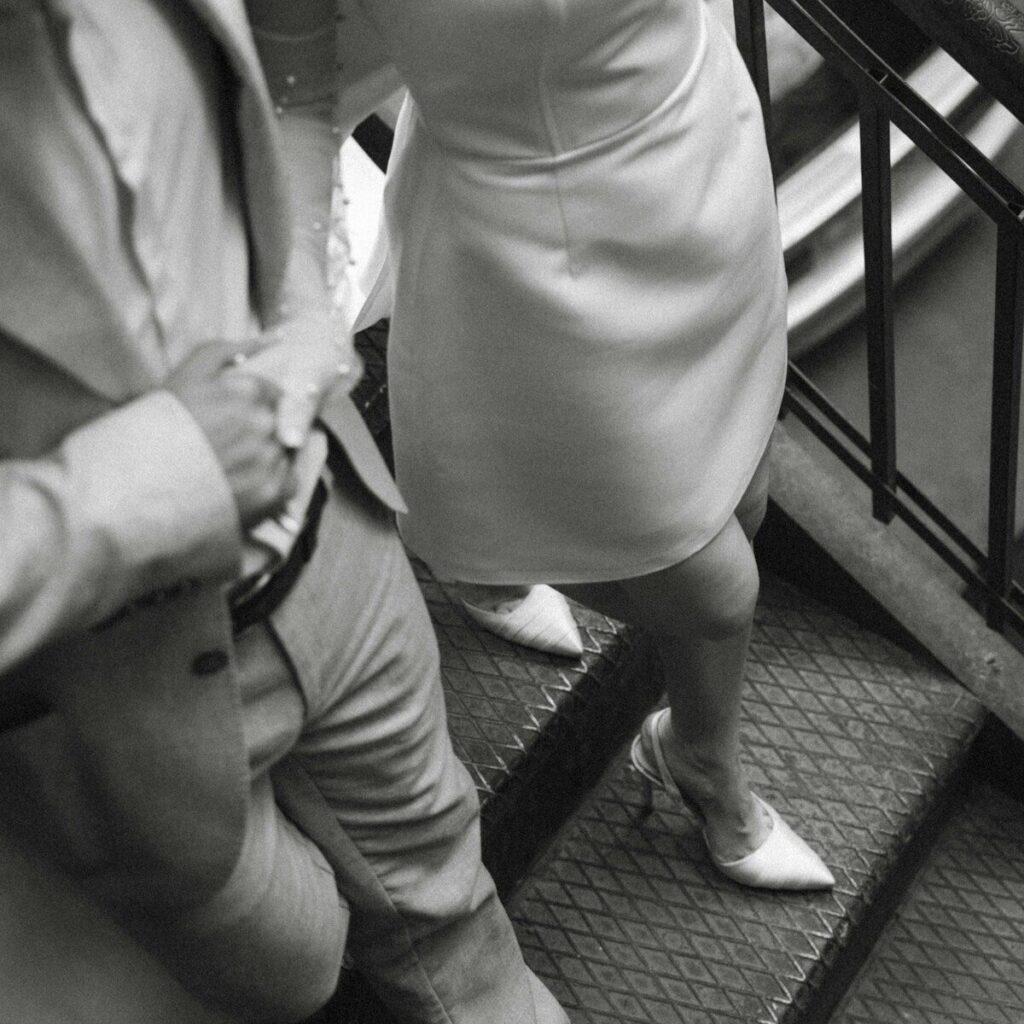 A man and a woman walking down a flight of stairs